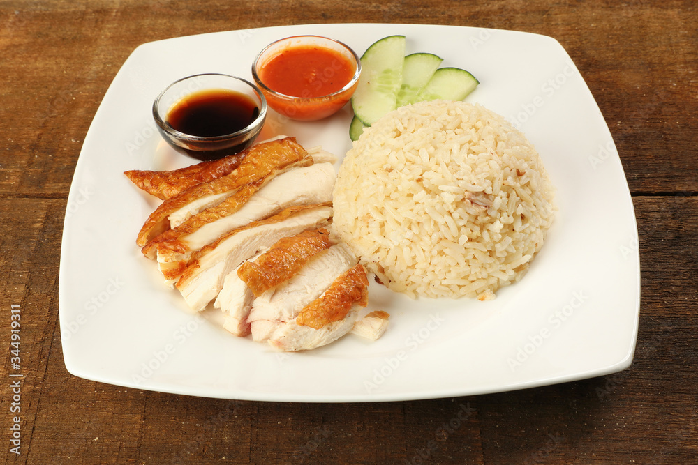 South east asian style chicken rice set steamed roasted sliced chicken with soup dark chilli sauce malaysia china South east asian style chicken rice set steamed roasted sliced chicken with soup dark chilli sauce malaysia china