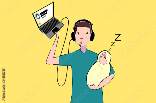 The father is holding his baby while he is in remote working from home.