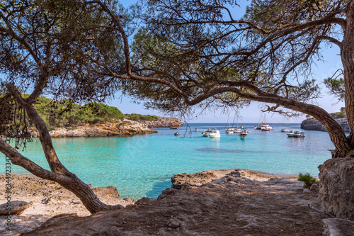 Seascape view of the famous bay Cala Turqueta with boats on the sea. Menorca, Balearic islands, Spain