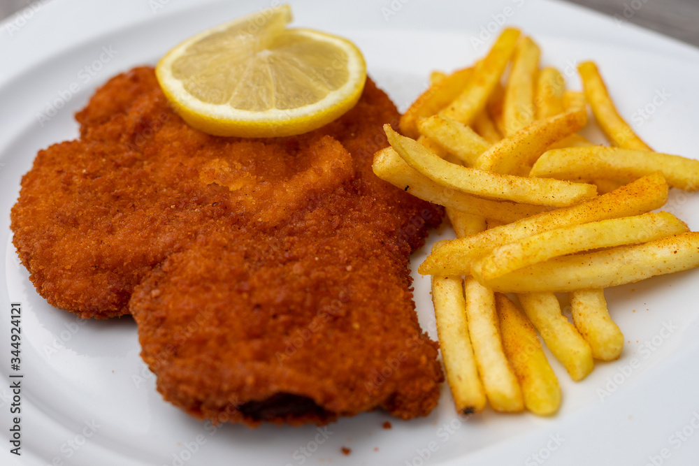 Breaded viennese schnitzel with french fries Breaded viennese schnitzel with french fries