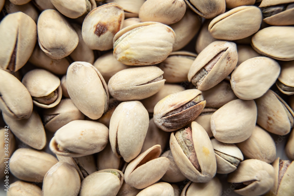Roasted and salted pistachios in shell (texture, background).