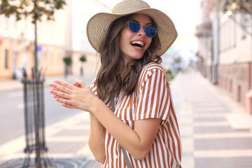 Portrait fashion woman is posing in the city, summer street fashion. Laughing and smiling portrait.