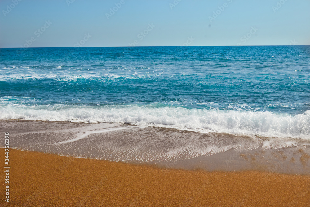 Blue sea waves at the Mediterranean beach in Antalya, Turkey.