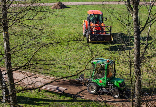 The tractor cleans the sidewalk