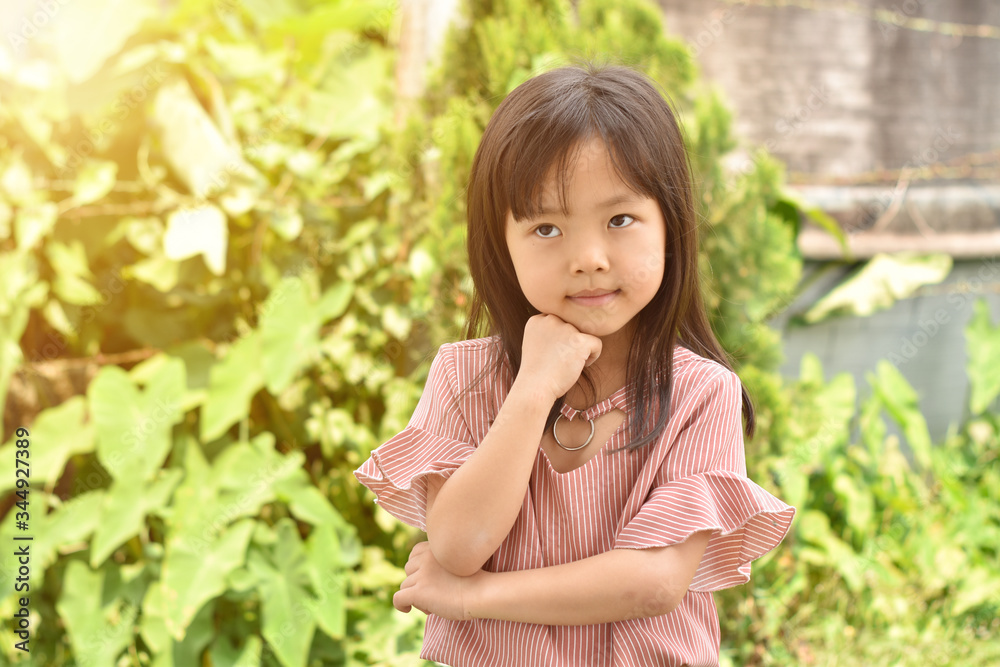 Portrait of little girl playing in the park on summer day. Portrait of little girl playing in the park on summer day.