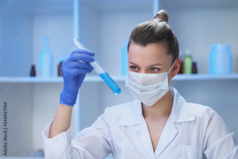A female medical scientist works in a laboratory. Spcialist conducts experiments, develops auccin auctin from the virus. Coronavirus covid-19. A female medical scientist works in a laboratory. Spcialist conducts experiments, develops auccin auctin from the virus. Coronavirus covid-19.