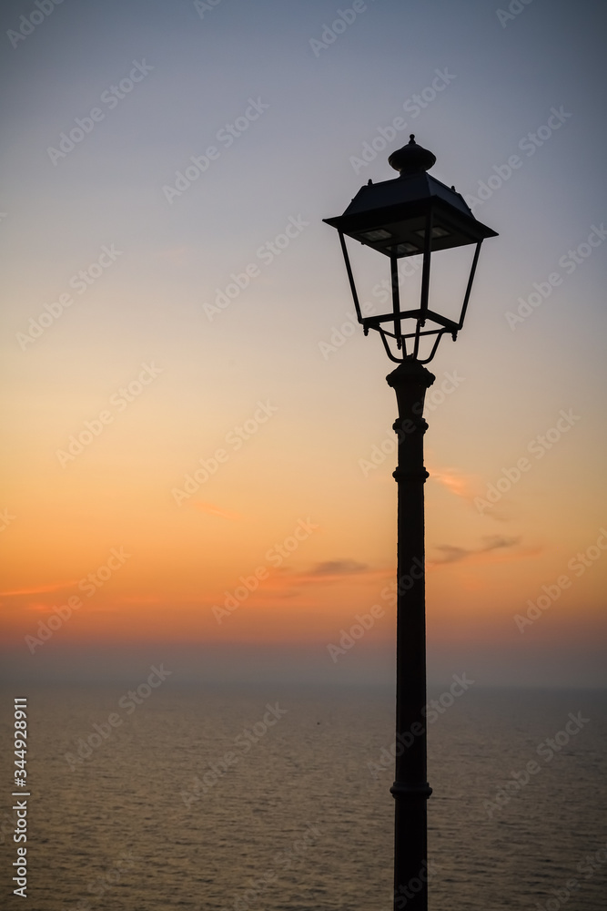 Siluette of old lamp with views on Mediterranean sea