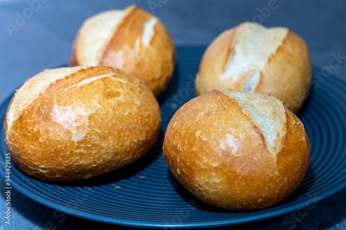 A few freshly baked bread rolls on dark background