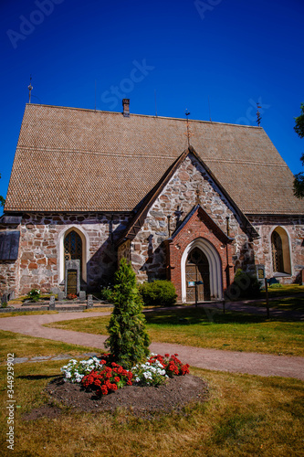 A medieval stone Nauvo Church (Nagu kyrka) from the middle of the 15th century stands in the middle of the village Kyrkbacken (Eng: Church hill). Storlandet Island, Turku Archipelago, Finland. photo