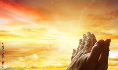 Prayer hands in sky