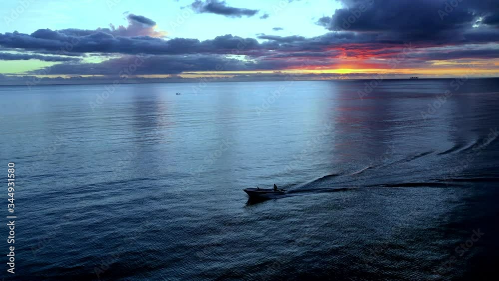 Aerial view flight at lagoon of Mauritius at sunset with a motor boat on the coast of Flic en Flac Aerial view flight at lagoon of Mauritius at sunset with a motor boat on the coast of Flic en Flac