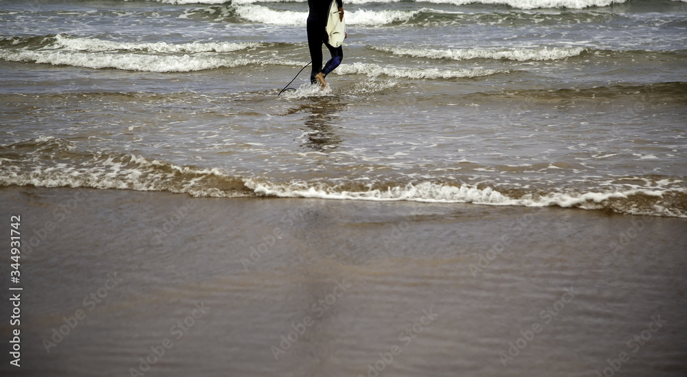 Surfer walking on the beach Surfer walking on the beach