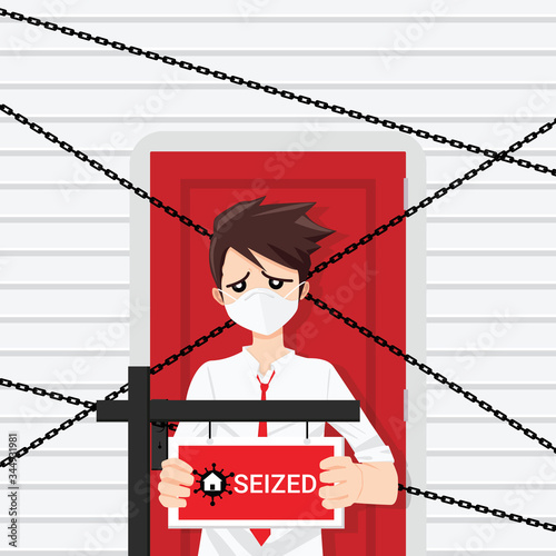 House with chains be confiscated because of jobless and economic depression due to pandemic of Covid-19 Concept. The sad business man holding a sign with the home in virus signs and text seized