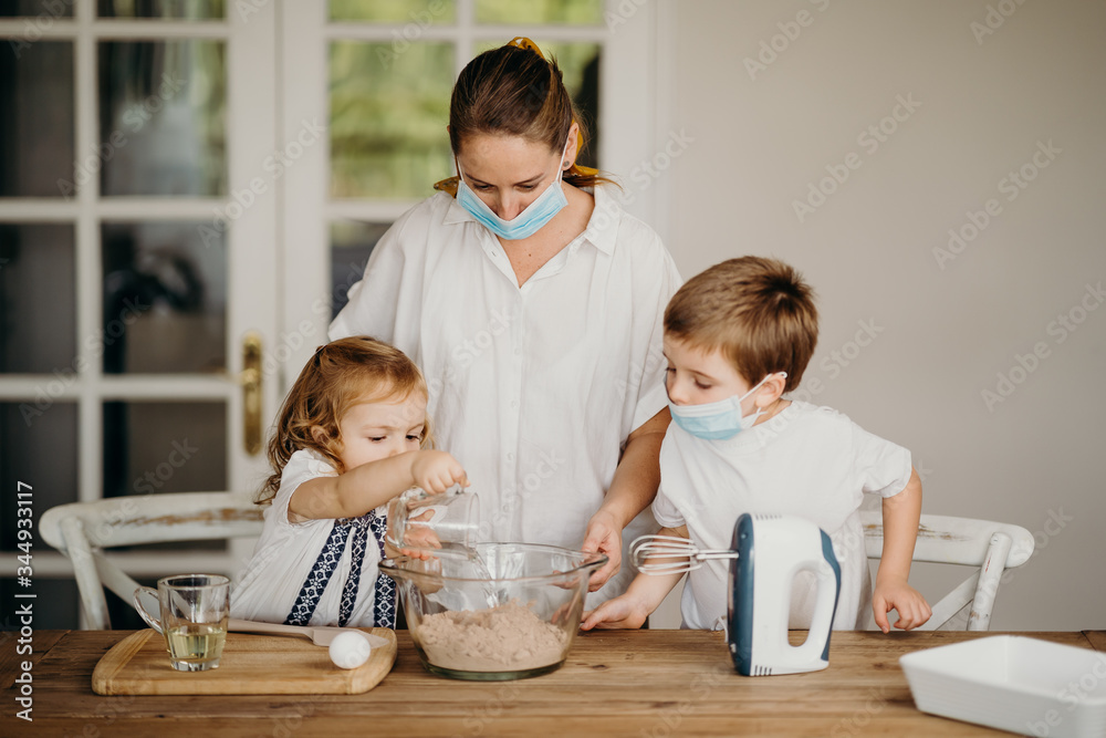 Beautiful family cooking together at home during home lock down due to coronavirus quarantine