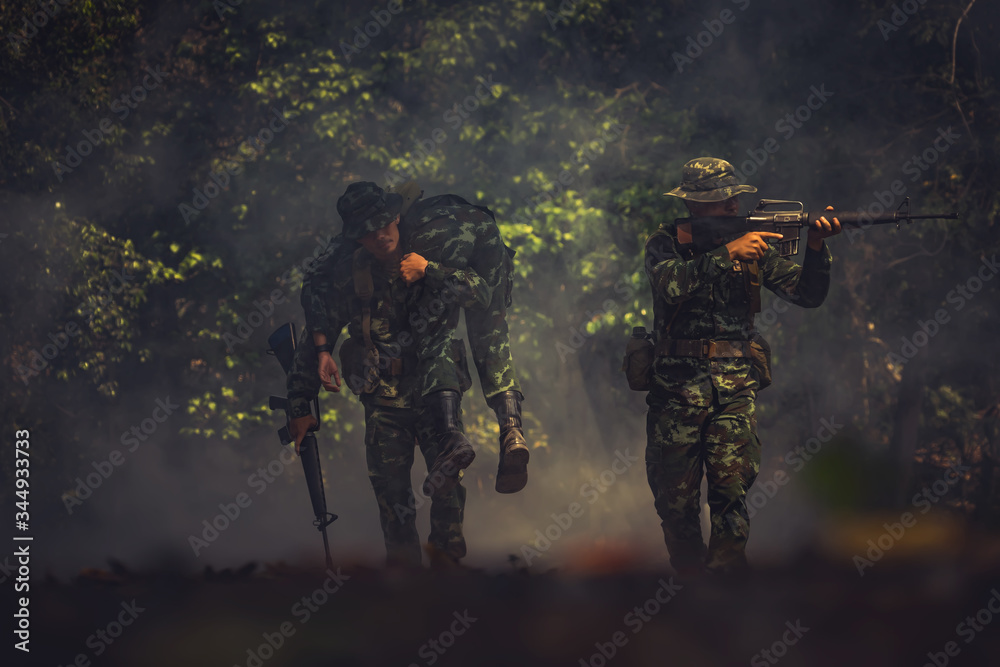 army soldier with rifle and machine gun moving .Thai army soldier in combat uniforms with machine gun.