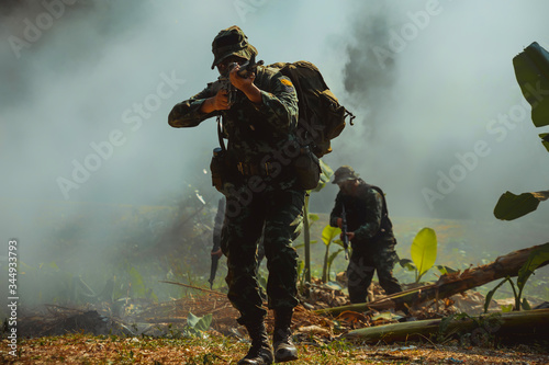 army soldier with rifle and machine gun moving .Thai army soldier in combat uniforms with machine gun.
