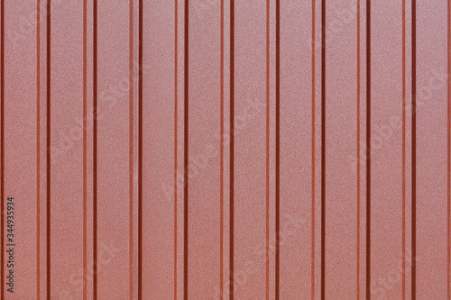 Brown corrugated steel sheet with vertical guides.