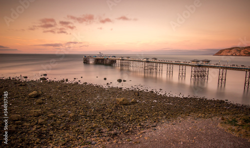 Sunset over Llandudno pier at low tide