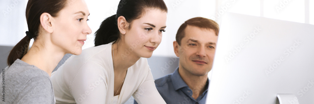 Group of business people discussing questions at meeting in modern office. Headshot at negotiation or workplace. Teamwork, partnership and business concept Group of business people discussing questions at meeting in modern office. Headshot at negotiation or workplace. Teamwork, partnership and business concept