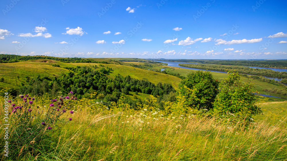 hills overgrown with grass and trees on the banks of the Vyatka River hills overgrown with grass and trees on the banks of the Vyatka River