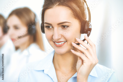 Call center. Focus on beautiful business woman in headset