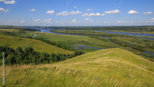 hills overgrown with grass and trees on the banks of the Vyatka River © Андрей Пугачев
