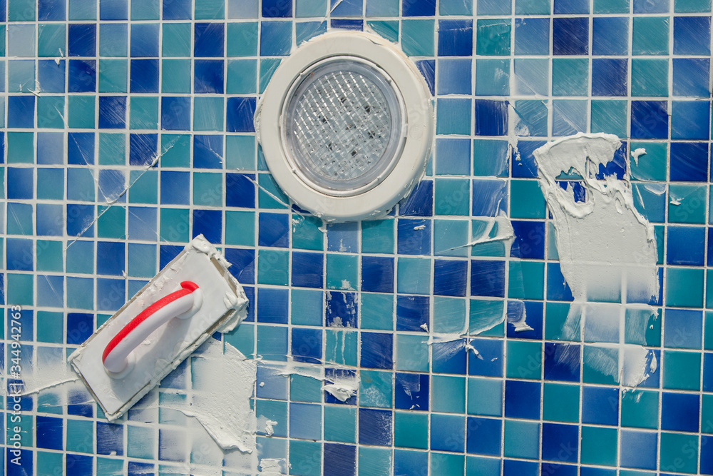 repairing and service of the pool. grouting tiles in the pool. Applying