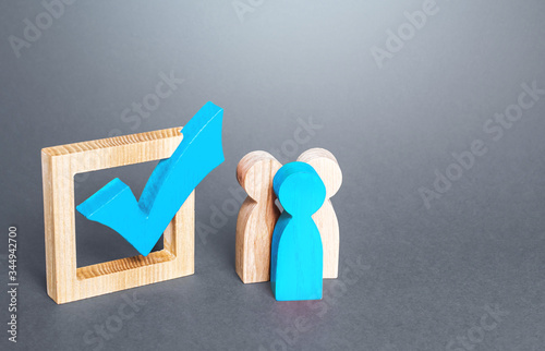 People are standing next to green check mark. Run for election. Public poll. Legislative Initiative. Lobbying interests. Resolution. Voting on democratic election or referendum. Political campaign. photo