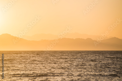 hazy  colorful  orange sunset over layers of mountains on the nile of egypt