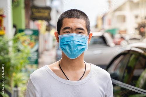 Asian man is wearing surgical mask during covid19 or corona virus spread