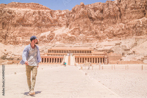 traveler walking toward temple of Hatshepsut in Egypt © Zach