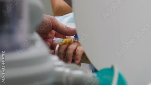 Surgical operation being perfomed. operation in clinic, patient under anesthesia with facial mask on, little boy fell asleep in dentists chair after he was put on oxygen mask to perform dental photo