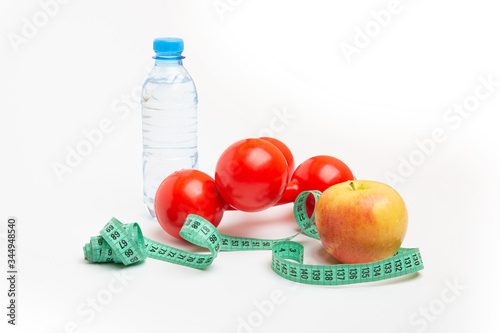 bright orange with a water bottle and red dumbbells, Measuring tape on a white background