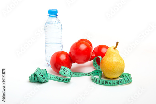 Fototapeta Naklejka Na Ścianę i Meble -  bright pear with a water bottle and red dumbbells, Measuring tape, on a white background