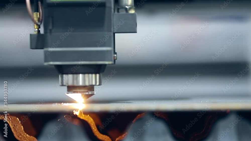 Blue color Laser CNC cut of metal with light spark, technology modern industrial Blue color Laser CNC cut of metal with light spark, technology modern industrial