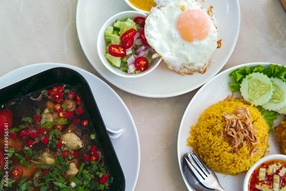 Top view of Southern Thai Style Food. Biryani Rice with egg, salad andSoup.