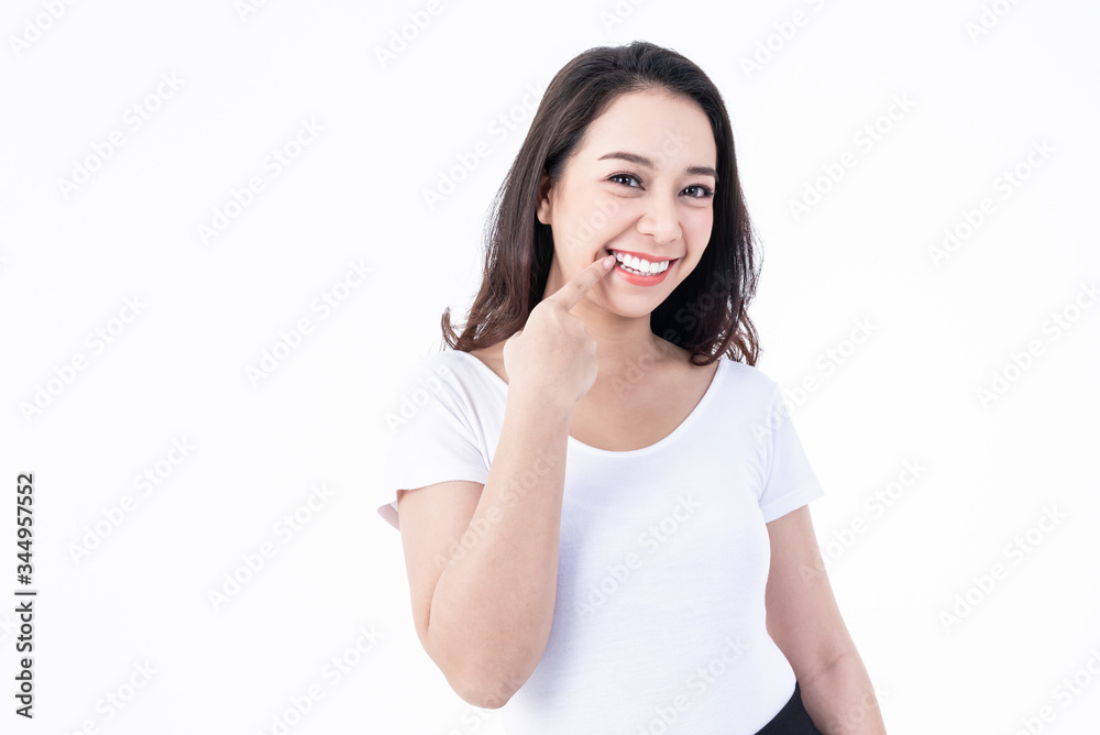 Portrait images of Asian young, pretty woman are smiling and Show teeth that are white, clean and healthy teeth On white background, to Oral and dental health concept. Portrait images of Asian young, pretty woman are smiling and Show teeth that are white, clean and healthy teeth On white background, to Oral and dental health concept.