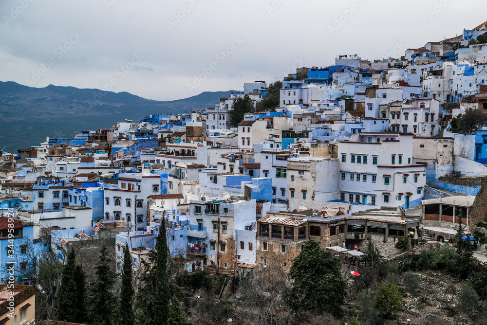 view of blue city with mountains in morocco 
