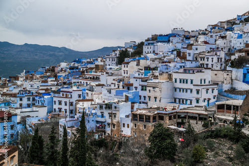 view of blue city with mountains in morocco  © Zach