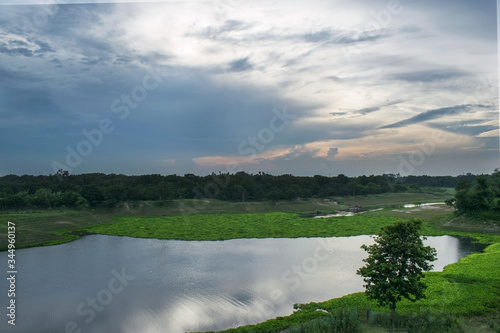 Fototapeta Naklejka Na Ścianę i Meble -  landscape of an beautiful afternoon with river and cloudy cold weather with green nature