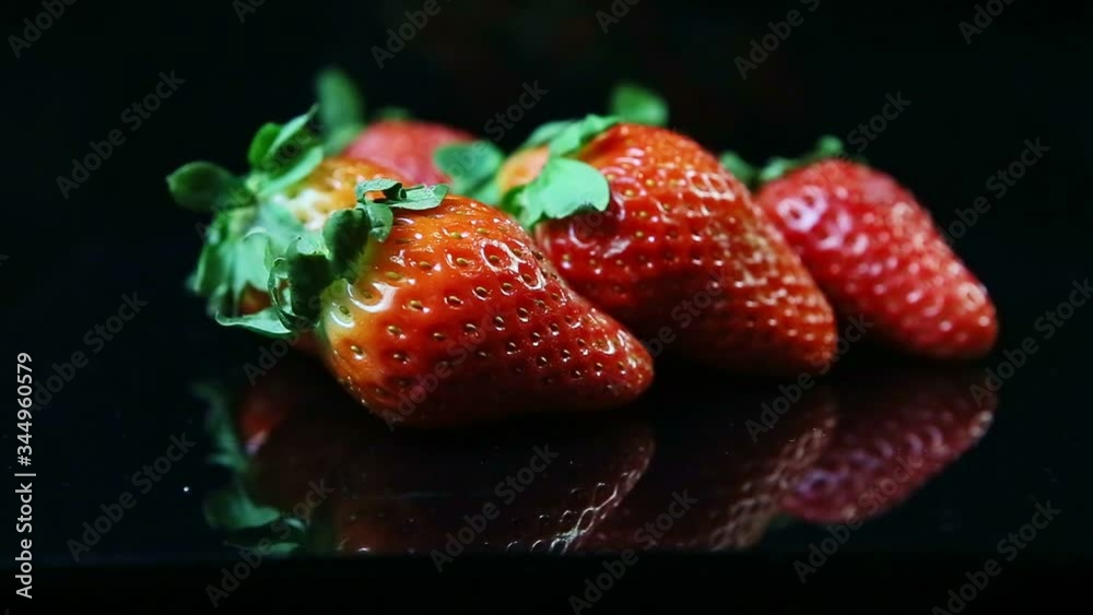 closeup focus changing at group of whole fresh ripe juicy red strawberries closeup focus changing at group of whole fresh ripe juicy red strawberries