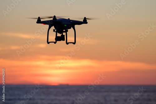 Drone quadcopter at sunset