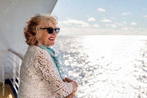 Side view of smiling senior woman on cruise photo