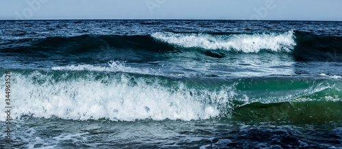 Summer. Sea. Sandy beach and fine sand. Small waves. Background.