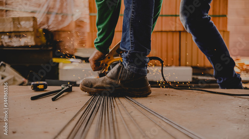 construction worker cutting concrete