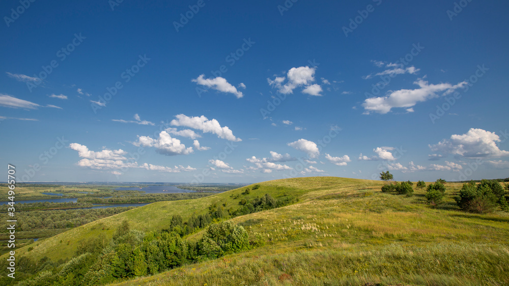 hills overgrown with grass and trees on the banks of the Vyatka River