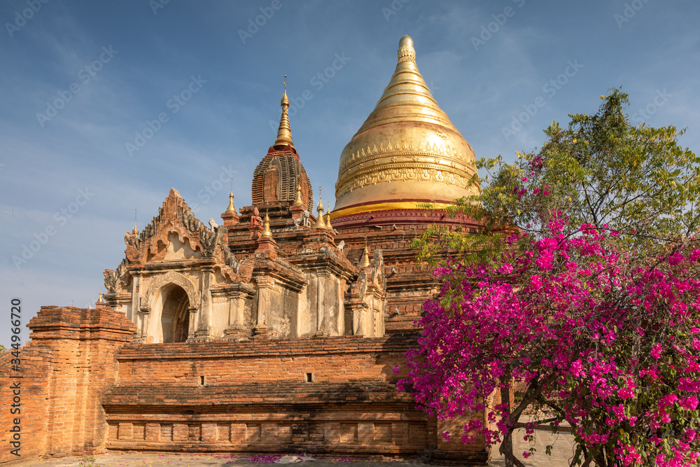 Golden Dhammayazik stupa under a blue sky