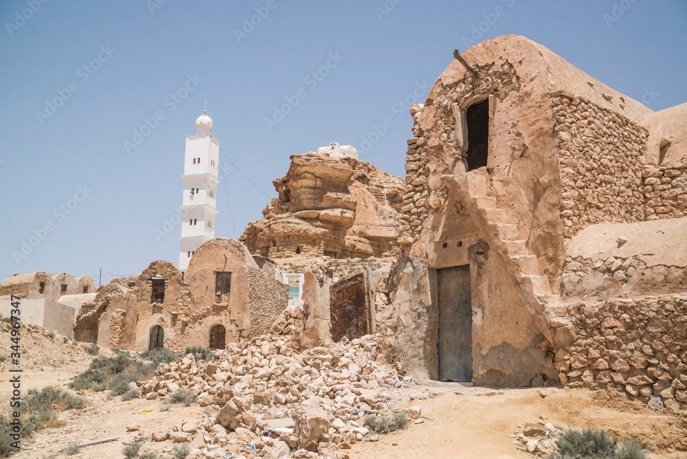 mosque and crumbled buildings of old town in tunisia
