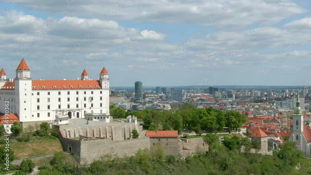 Aerial of Bratislava Castle, Slovakia - Cinematic Establishing Pan Shot of a Medieval Fairytale Bratislava Castle With Ancient Walls and Bratislava Cityscape, During a Quiet Sunny Day Aerial of Bratislava Castle, Slovakia - Cinematic Establishing Pan Shot of a Medieval Fairytale Bratislava Castle With Ancient Walls and Bratislava Cityscape, During a Quiet Sunny Day