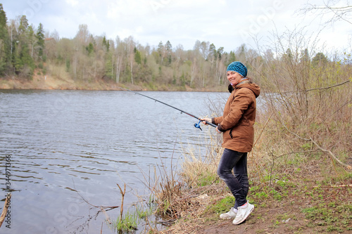 woman with fishing rod on the river